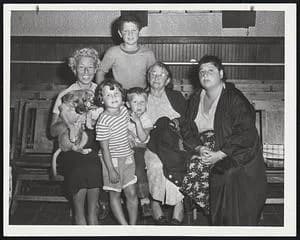 Stanley Cohen - Huddled Out of the Storm, this group of women and children gather at the Red Cross center in Our Lady of Lourdes Church in Revere. Left to right are Miss Diana Cohen; Robin Mack, 4; He
