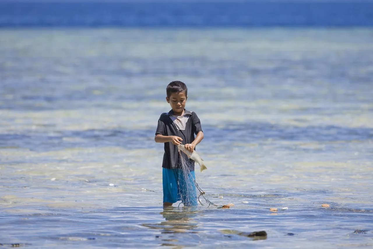 Kingsley Amis — boy, fishing, halmahera, nature, widi islands, ami, indonesia, uchin, tropical, sea, coral reef