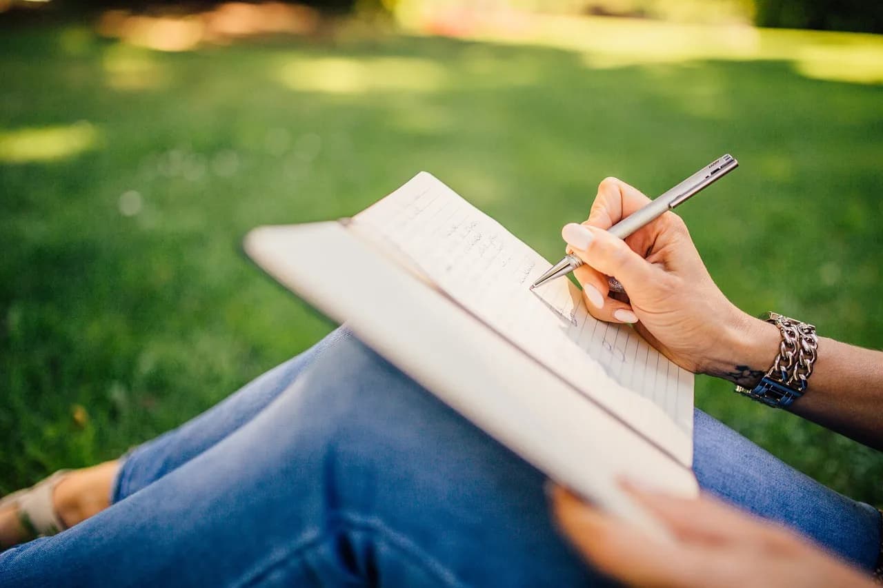 Roger Zelazny — writing, writer, notes, pen, notebook, book, girl, woman, people, nature, hands, grass, outdoors