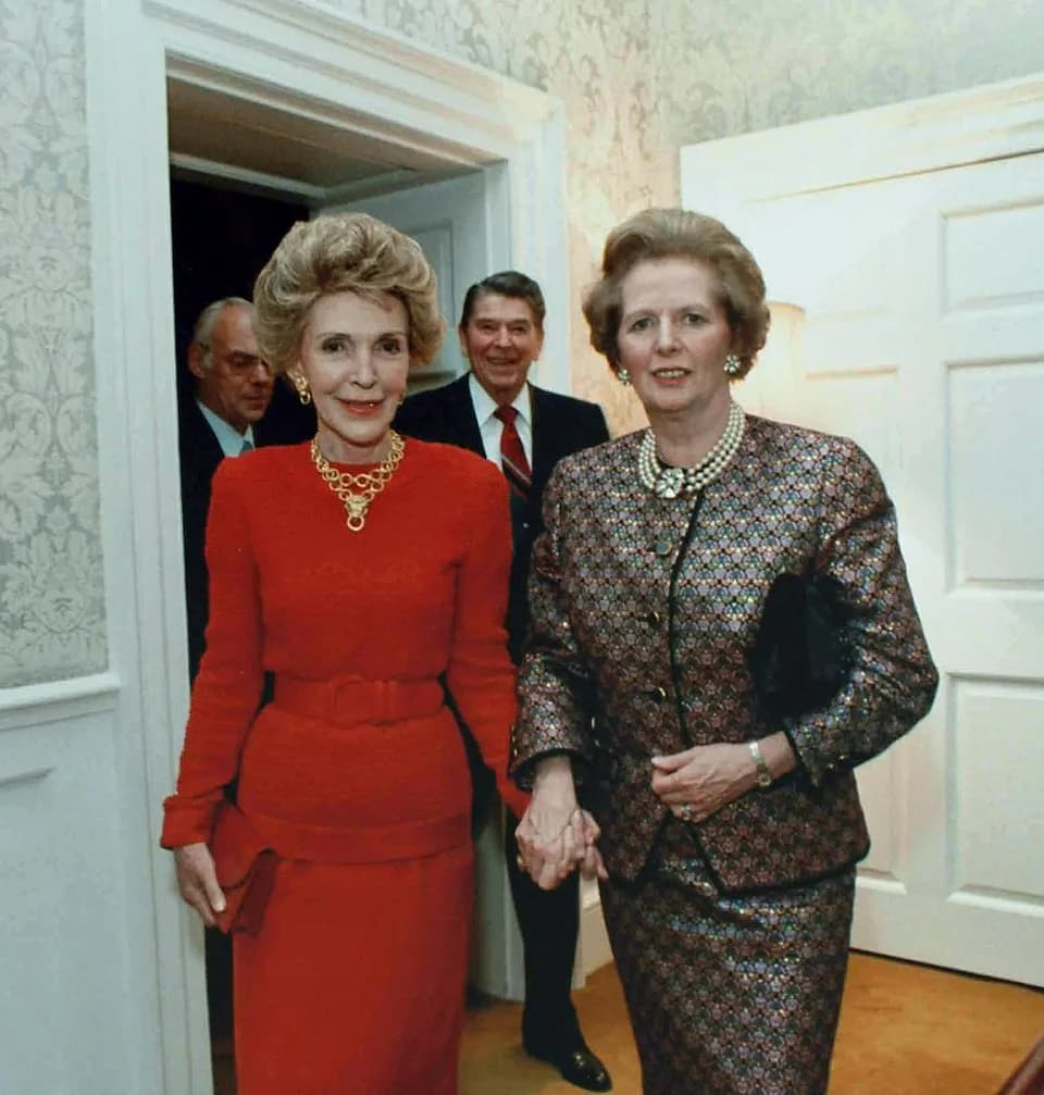 Margaret Thatcher - Margaret Thatcher and Nancy Reagan at 10 Downing Street. President Ronald Reagan is behind, in between the two, and Mr. Denis Thatcher is to Mr. Reagan's left.