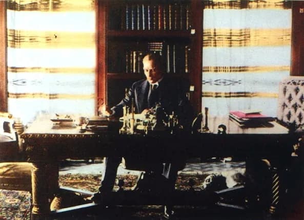 Mustafa Kemal Atatürk - Atatürk at the library of Çankaya Köşkü Presidential Residence on July 16, 1929. His dog Foks can be seen lying on the floor, under the table.
Kemal Atatürk (or alternatively w