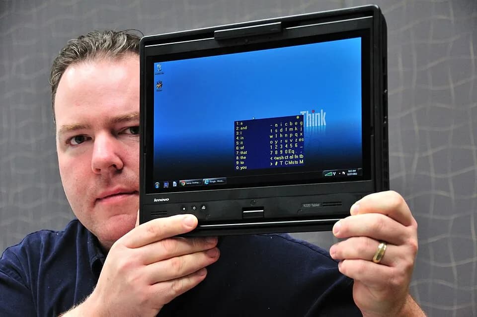 Stephen Hawking - Intel engineer Travis Bonifield holds a replica of the custom PC "Lenovo ThinkPad X220 Tablet" he recently created for Stephen Hawking.