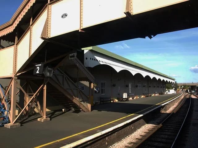 Agatha Christie - Churston station. A view through an open carriage window of the northbound platform at the station. "The station was opened in 1861 as the temporary terminus of the Kingswear line. I