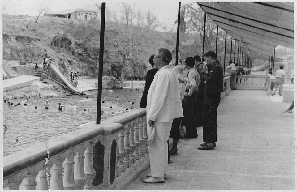 Leon Trotsky - Scope and content:  Trotsky is standing on a balcony overlooking swimmers in a river at Hot Springs, Mexico. ca. May 1938.