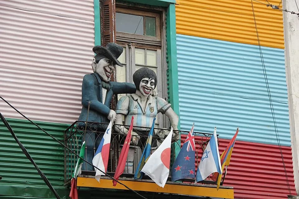Diego Maradona - Caminito streets in Buenos Aires. Dolls on balcony.