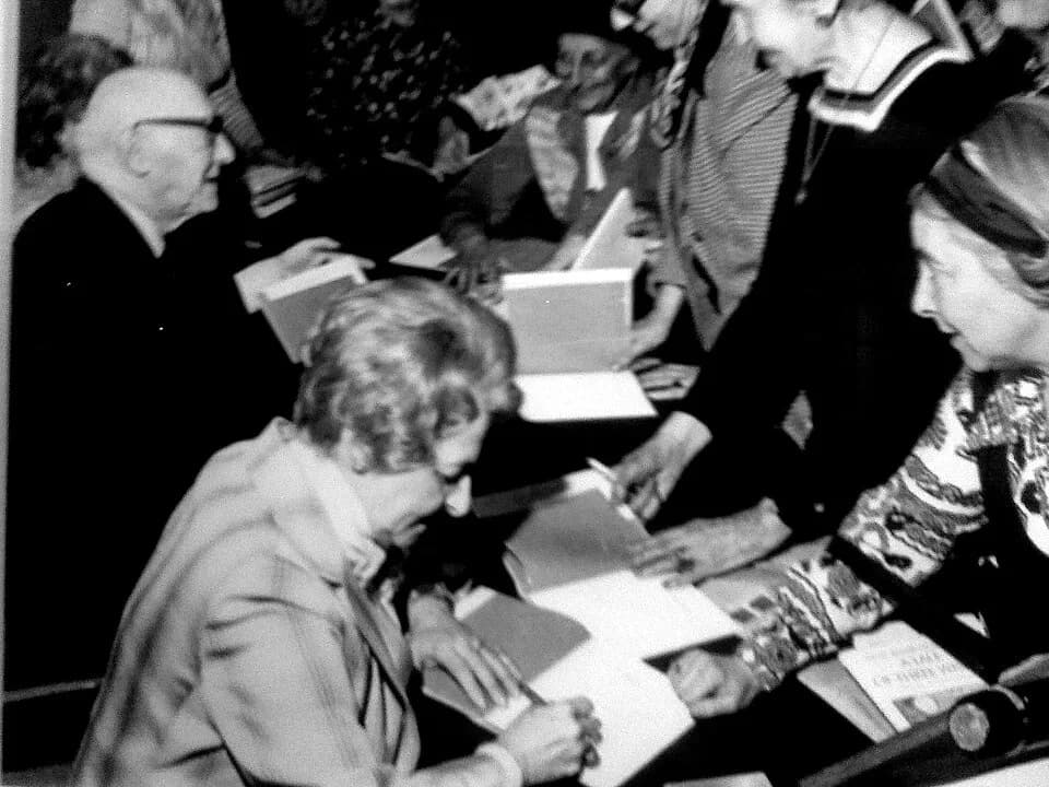 Isaac Bashevis Singer - Irene Lieblich signing autographs beside Nobel laureate Isaac Bashevis Singer, whose award-winning literature she illustrated.
