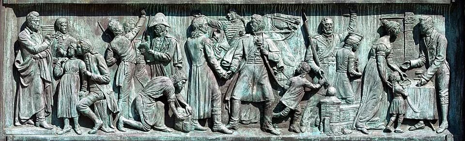 Johann Gottlieb Fichte - Friedrich Wilhelm III.-Reiterstandbild auf dem Kölner Heumarkt.Detail: Sockelrelief an der Südseite: „Freiheitskriege“. Von Links nach Rechts: Johann Gottlieb Fichte, Friedric