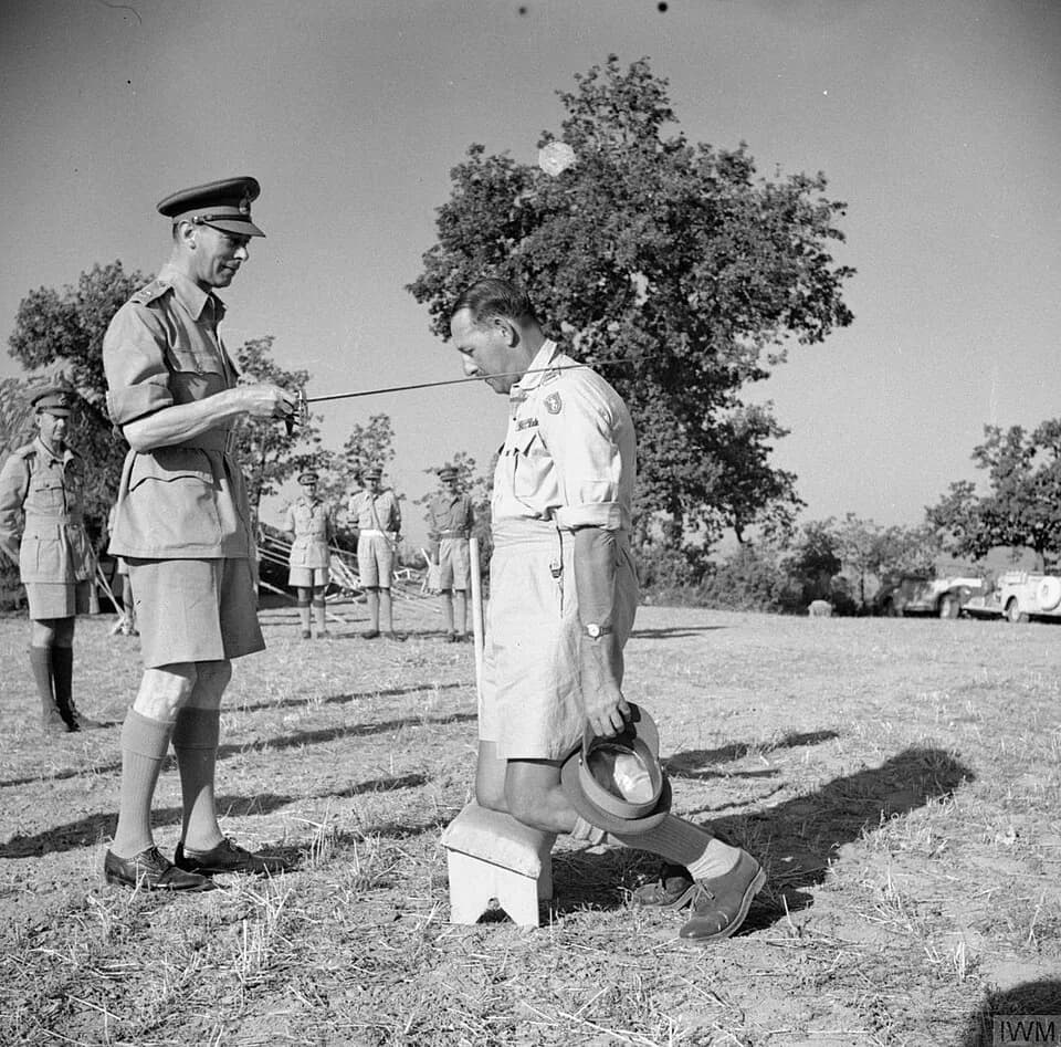 George VI - THE BRITISH ARMY IN ITALY 1944. King George VI knights General Sir Oliver Leese in the field.