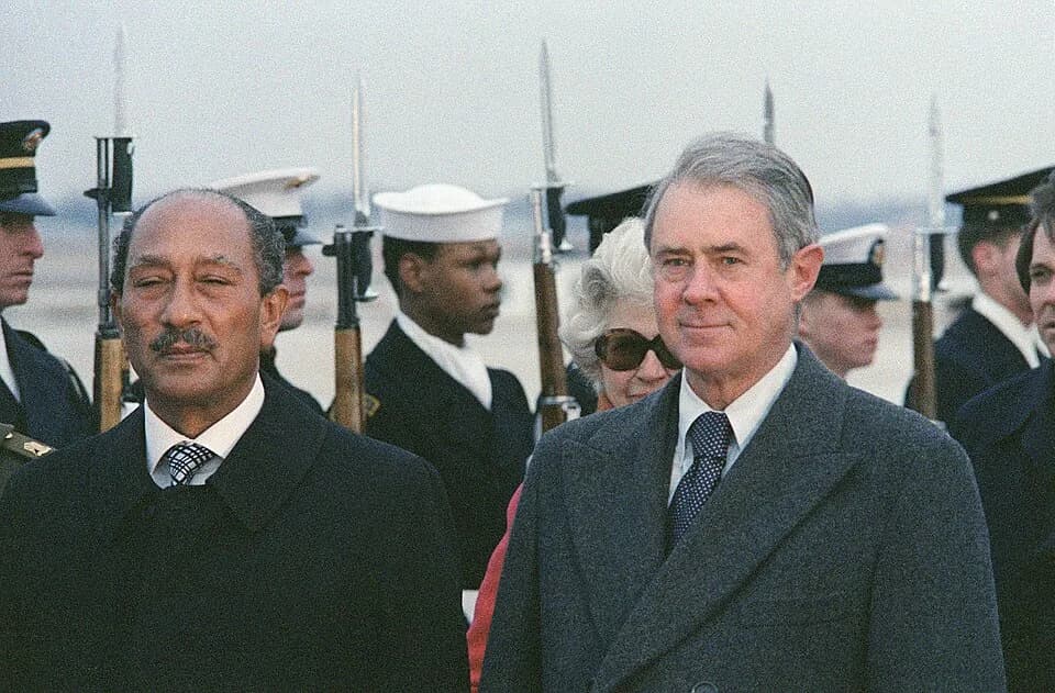 Anwar Sadat - Egyptian President Anwar el-Sadat (left) receives military honors upon his arrival in the United States. He is accompanied by US Secretary of State Cyrus R. Vance (right).
