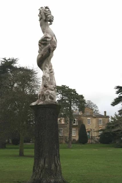 C. S. Lewis - Sculpture Bury Knowle Park, Headington, Oxfordshire. The trunk of the dead cedar tree has been carved into a sculpture featuring characters from the books of the Headington authors J. R.