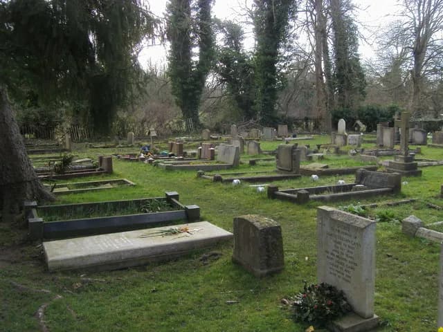 C. S. Lewis - Churchyard of the Church of England parish church of the Holy Trinity, Headington Quarry, Oxford. The grave of C.S. Lewis the slab on the left with a spray of flowers on it.