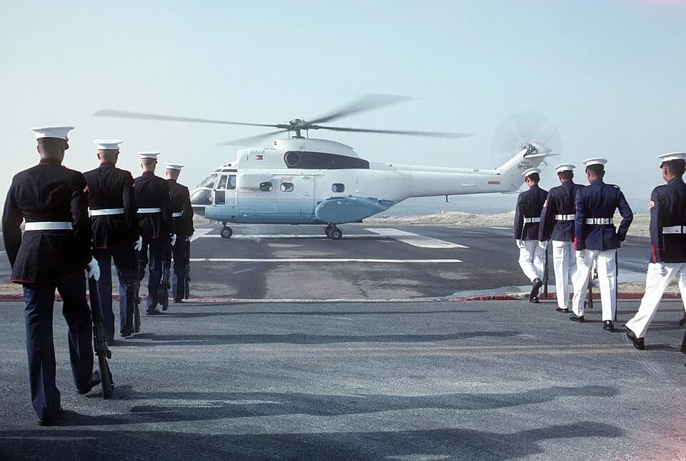 Corazon Aquino - NAVAL STATION, SUBIC BAY, LUZON PHILIPPINES (PHL) - A joint U.S.-Philippine Marine honor guard marches in formation as an SA-330 Puma helicopter transporting Philippine President Cora