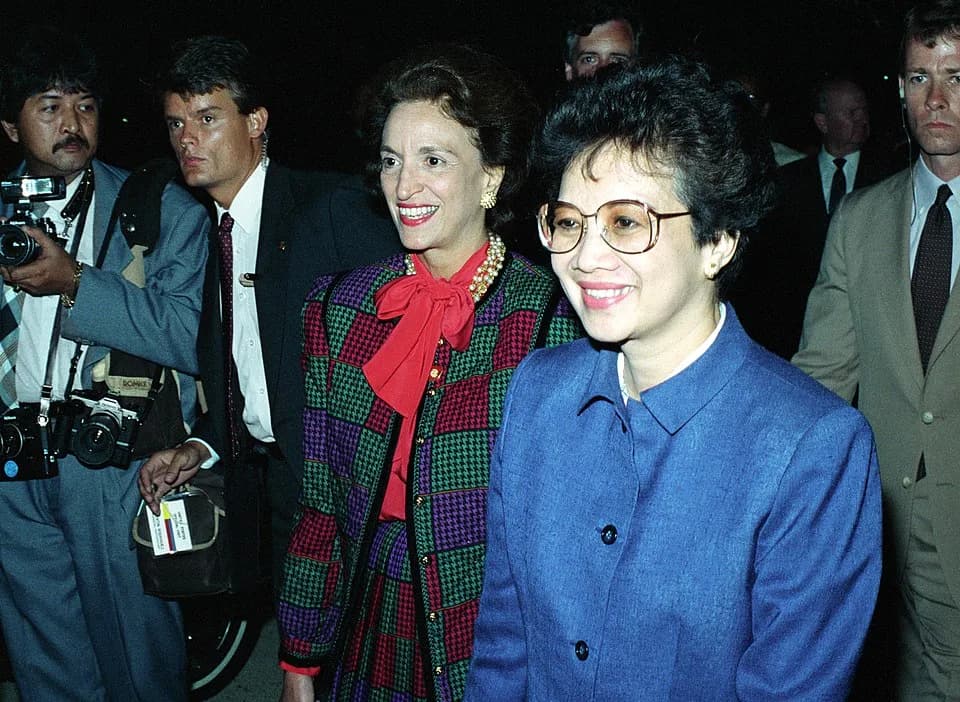 Corazon Aquino - Philippine President Corazon C. Aquino greets officials as she walks across the flight line to the passenger terminal at Andrews Air Force Base.