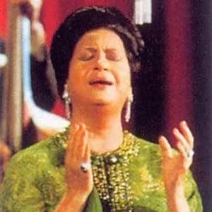 Umm Kulthum - A photo for Umm Kulthum singing on a stage.