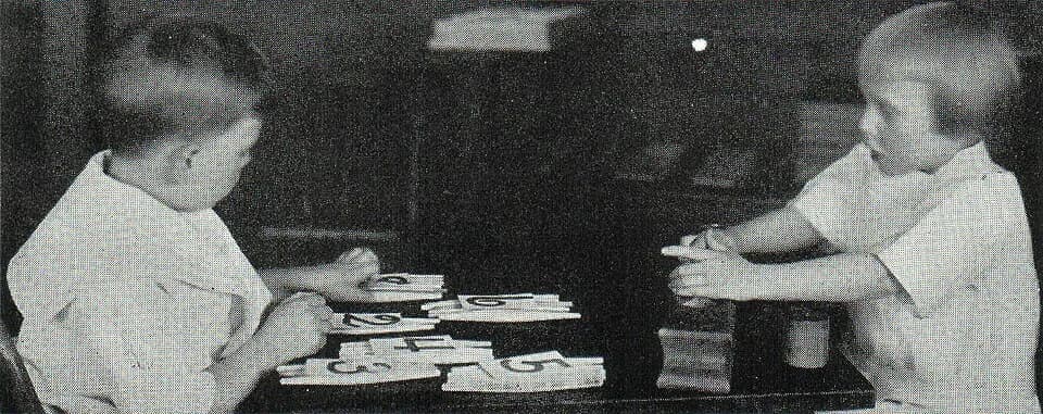 Maria Montessori - Montessori System:  .mw-parser-output .smallcaps{font-variant:small-caps}Children Using Counting and Geometrical Devices. The child on the left is placing figure cards over the corr