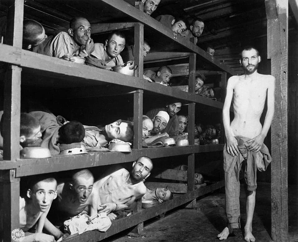 Elie Wiesel - These are slave laborers in the Buchenwald concentration camp near Weimar; many had died from malnutrition when U.S. troops of the 80th Division entered the camp. The very ill man lying
