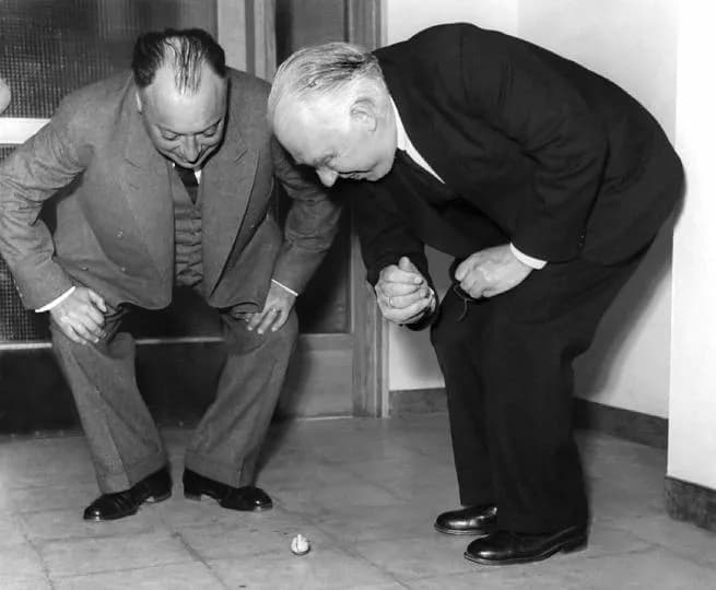 Wolfgang Pauli - Wolfgang Pauli and Niels Bohr demonstrating 'tippe top' toy at the inauguration of the new Institute of Physics at Lund; Sweden