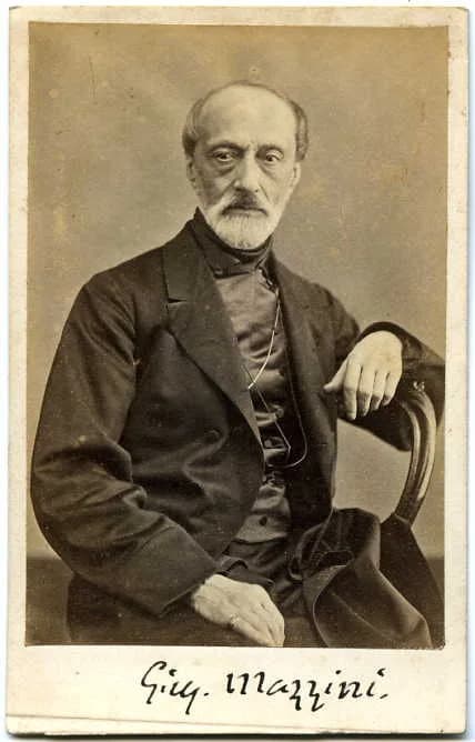 Giuseppe Mazzini - Black and white photographic portrait of Giuseppe Mazzini by Domenico Lama (1823-1890) with G.M.'s signature at the bottom.