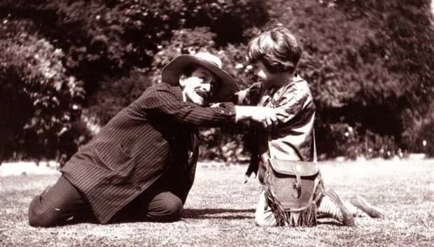 J. M. Barrie - J. M. Barrie (as Hook) and Michael (as Peter Pan) on the lawn at Rustington, August 1906