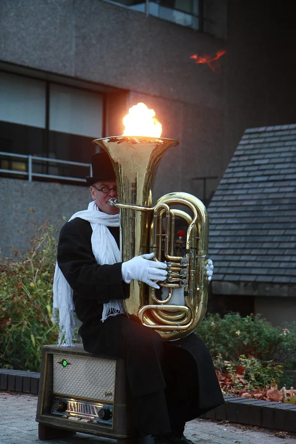 René Magritte - Man playing a tuba with flames emerging from the bell in South Bank, London, UK.
