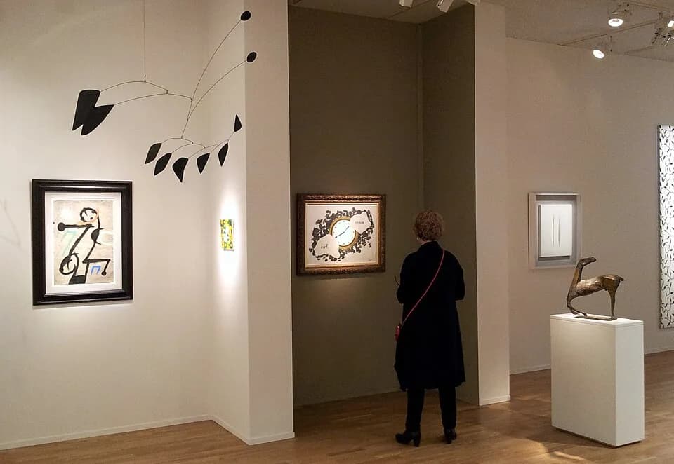 René Magritte - Maastricht, the Netherlands. View of an art dealer's stand at TEFAF 2014, The European Fine Art Fair. Here: works by Alexander Calder, René Magritte, Lucio Fontana and Marino Marini.