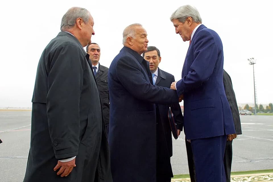 Islam Karimov - U.S. Secretary of State John Kerry shakes hands with Uzbekistan President Islam Karimov -- as Ukbek Foreign Minister Abdulaziz Kamilov looks on -- after the Secretary arrived at Samark