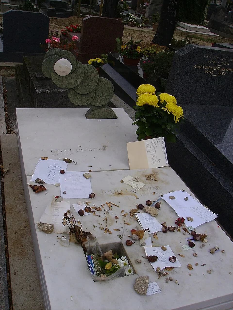 Julio Cortázar - Julio Cortázar's gravestone at Montparnassse Graveyard, Paris, with Hopscotchs designed by his admirers.