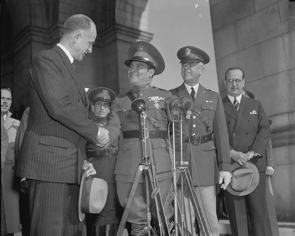 Fulgencio Batista - Cuba's Dictator greeted upon arrival. Washington, D.C., Nov. 10. Sumner Wells, The Undersecretary of State, shown shaking hands with Col. Fulgencio Batista as Gen. Malin Craig, the