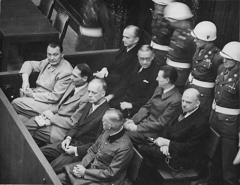 Karl Dönitz - Nuremberg Trials. Defendants in their dock, circa 1945-1946.
(in front row, from left to right): Hermann Göring, Rudolf Heß, Joachim von Ribbentrop, Wilhelm Keitel(in second row, from le