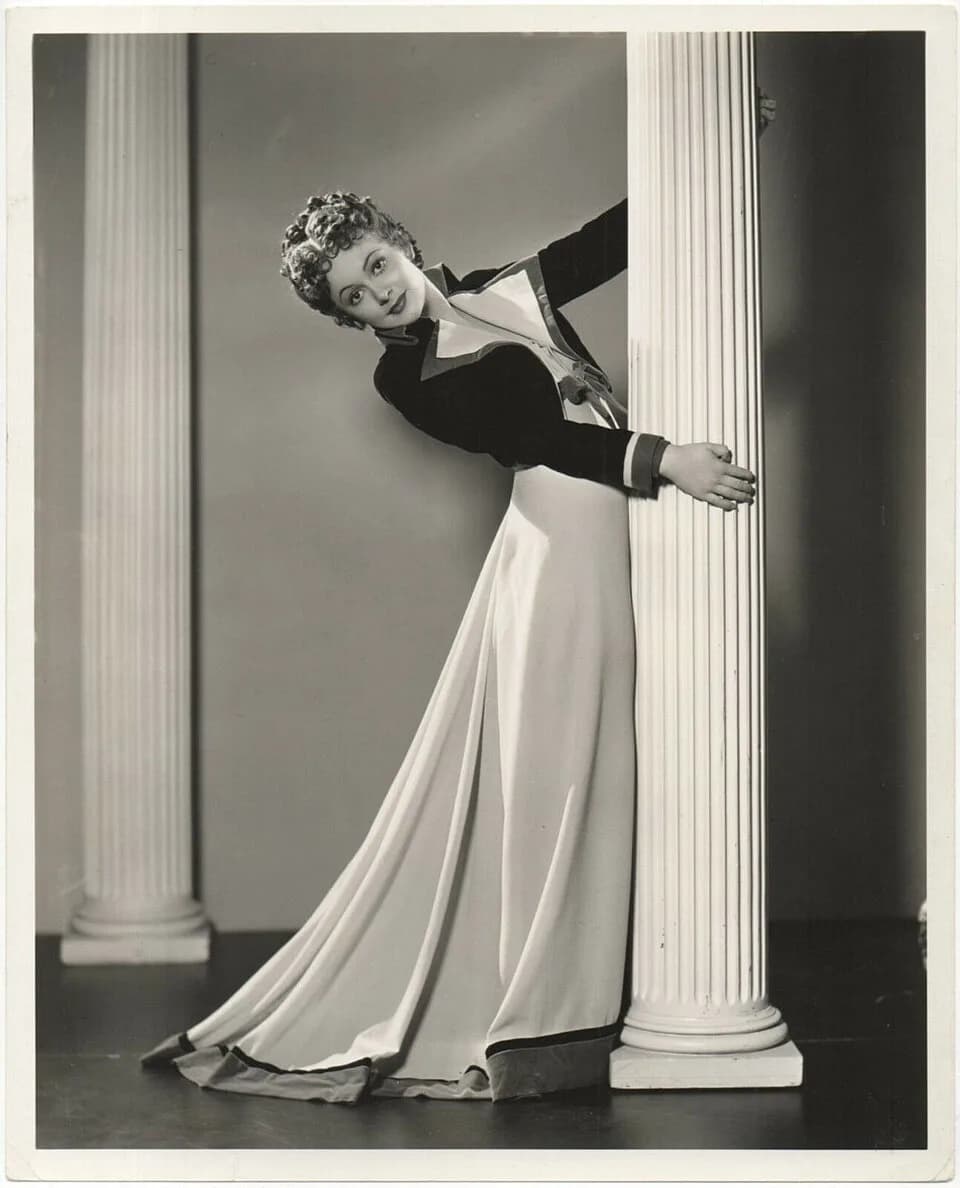 Olivia de Havilland - Olivia de Havilland. Publicity photo by Scotty Welbourne. On verso photographer's ink stamp