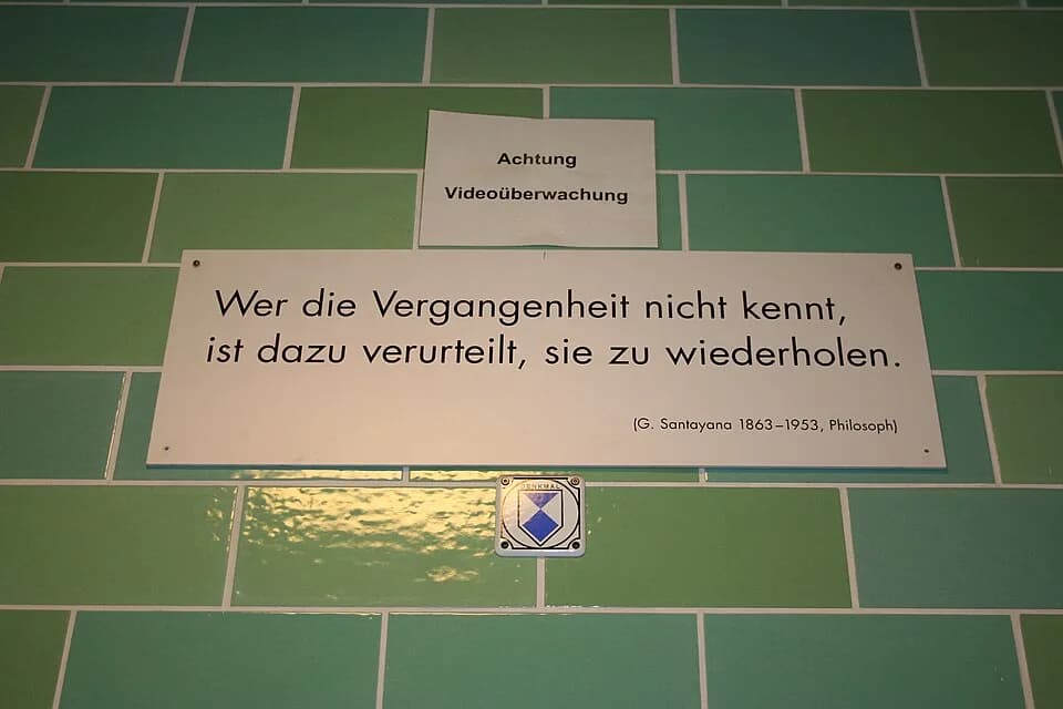 George Santayana - Plaque with quotation from George Santayana at the U-Bahn (subway) station Gesundbrunnen (Berlin). Translation: "Those who cannot remember the past are condemned to repeat it". The 
