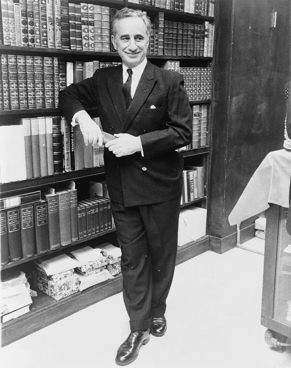Elia Kazan - Elia Kazan, full-length portrait, standing before bookshelves at Brentano's book store  / World Journal Tribune photo by James Kavallines.