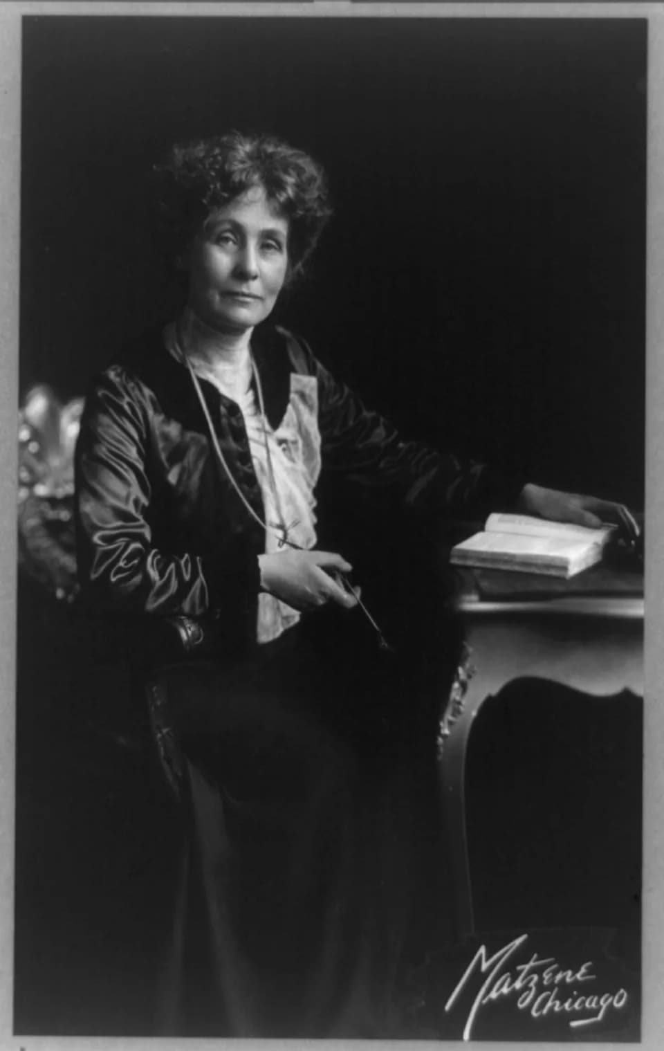 Emmeline Pankhurst - Emmeline (Goulden) Pankhurst, 1858-1929, 3/4 lgth., seated at table, facing slightly right.