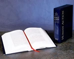 Ludwig von Mises - Two copies of Human Action Scholar's Edition by Ludwig von Mises on marble table, one open, other standing closed