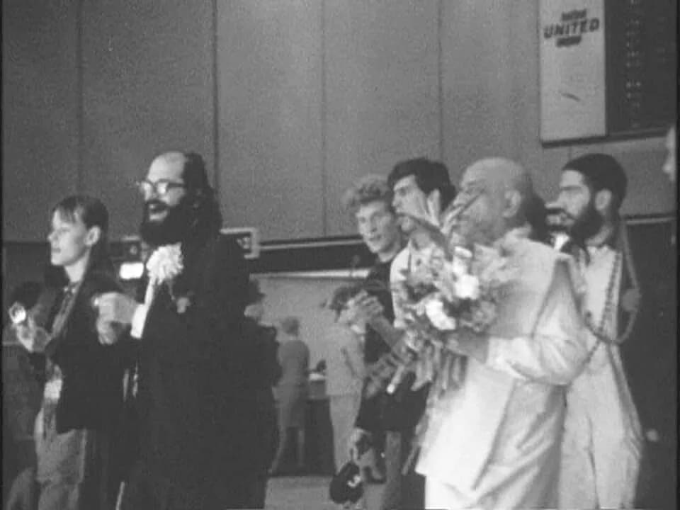 A. C. Bhaktivedanta Swami Prabhupada - Allen Ginsberg greets Bhaktivedanta Swami at the San Francisco Airport, January 17, 1967. (left to right) An unidentified person, Allen Ginsberg, Shyamasundara D