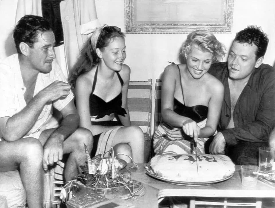 Errol Flynn - Photograph of a celebration of Rita Hayworth's 28th birthday, on board the Zaca, during the filming of The Lady from Shanghai
Newspaper caption reads as follows:RITA HAYWORTH HAS BIRTHDA
