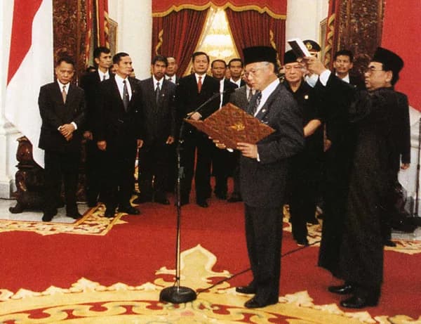 B. J. Habibie - Bacharuddin Jusuf Habibie takes the oath of office as President of Indonesia, replacing Suharto after his resignation.