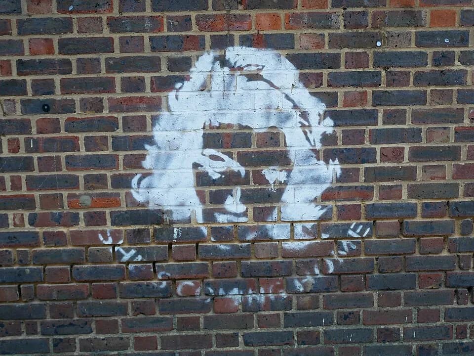 Angela Lansbury - Graffiti depicting Angela Lansbury on the south face of the Grade II listed Chrisp Street Market Clock Tower. The graffiti marked Lansbury's visit to the market for the Angela Lansbu