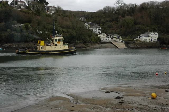 Daphne du Maurier - Tug boat on the River Fowey A tug boat cruises down the River Fowey, past Bodinnick which can be seen on the other side.