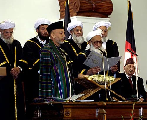 Mohammed Zahir Shah - Chief Justice Shinwani from the Supreme Court of Afghanistan (right) administers the Oath of Office for the Presidential Inauguration to Afghanistan President Hamid Karzai at the