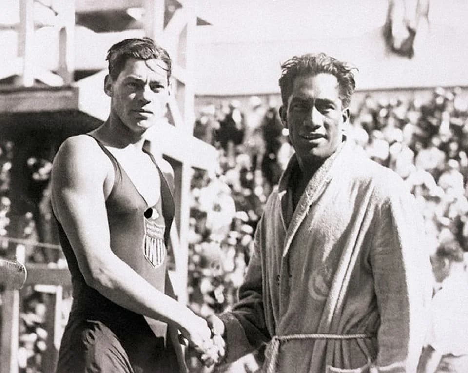 Johnny Weissmuller - The 1924 Olympic swimmers in France. Duke Kahanamoku and Johnny Weismuller, shaking hands.