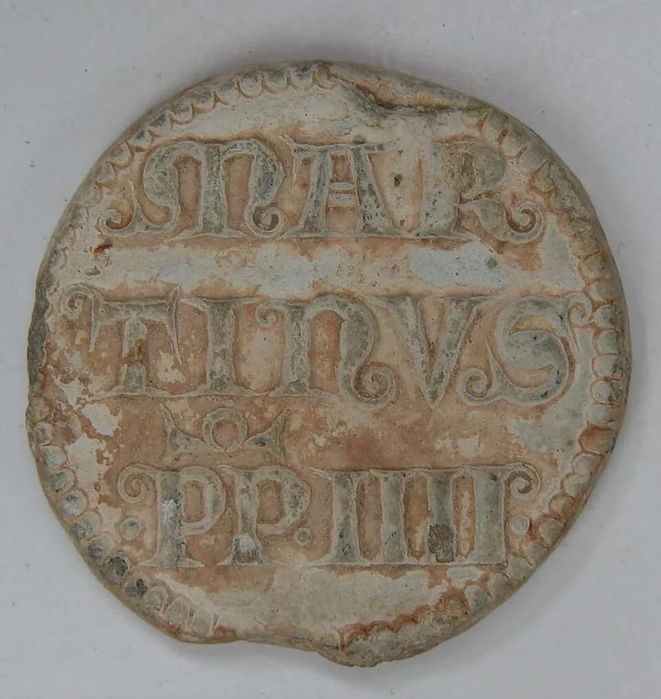 Martin IV - Lead papal bulla of Pope Martinus IV (1281-1285). The obverse depicts two bearded heads facing each other, with a cross-headed staff between them. Each head is surrounded by a beaded line,