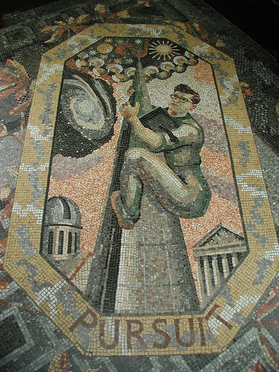 Fred Hoyle - Pursuit (1952) by Boris Anrep, part of a series of mosaics of the Modern Virtues in the entrance hall of the National Gallery, London. It depicts the astronomer Sir Fred Hoyle as a steepl