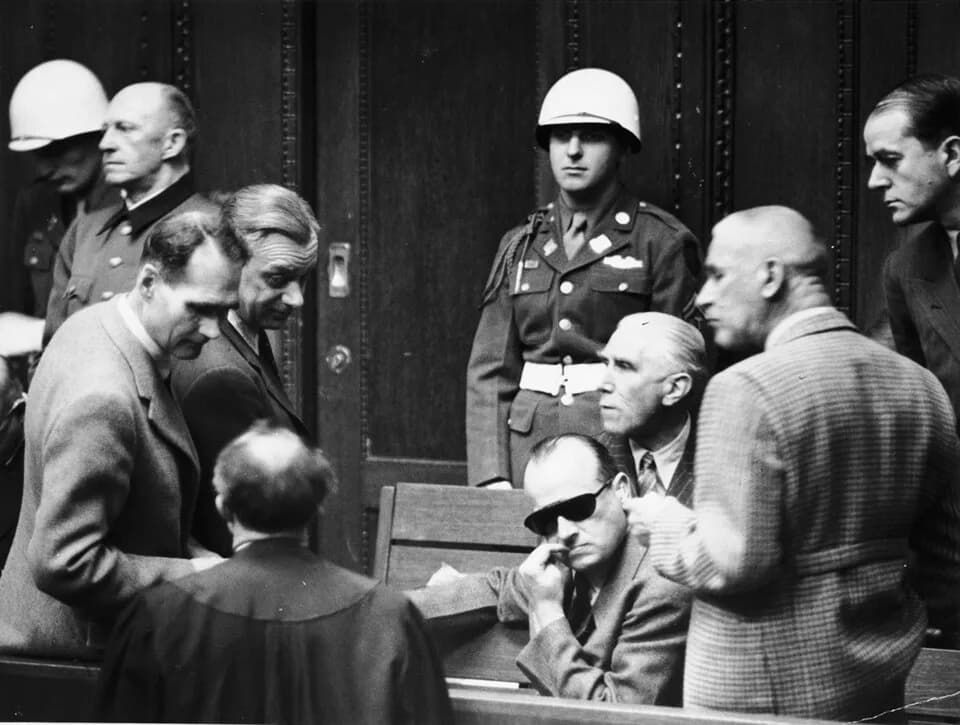 Hans Frank - Defendants talk to each other and to their lawyer during a break at the International Military Tribunal in Nuremberg.
Among those pictured from left to right are Rudolf Hess, Alfred Rosen