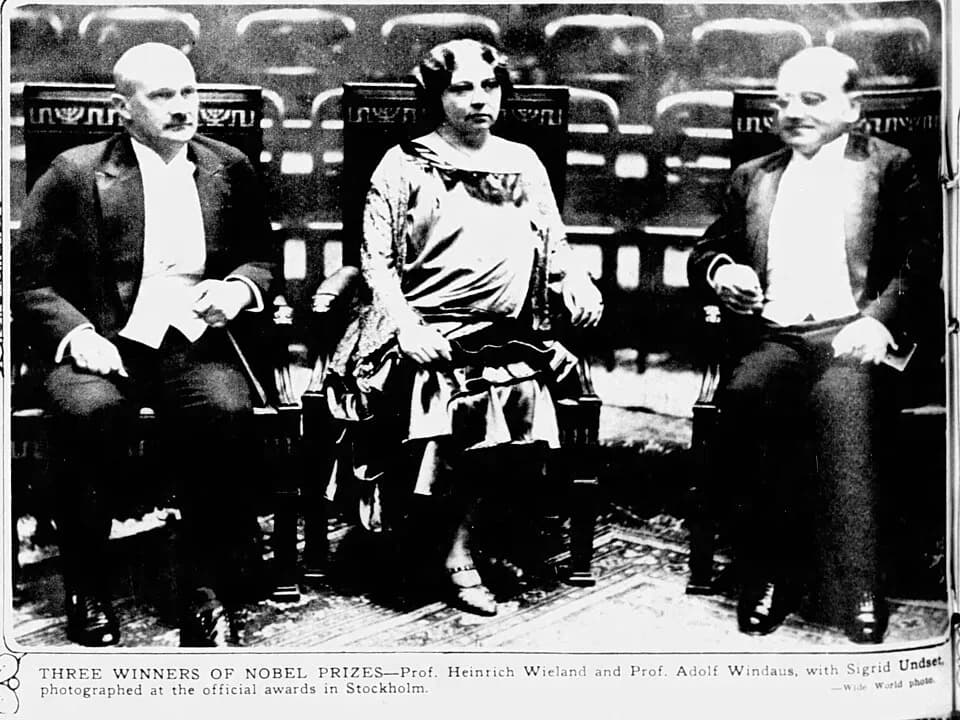 Adolf Windaus - Caption text says "THREE WINNERS OF NOBEL PRIZES Prof. Heinrich Wieland and Prof. Adolf Windaus, with Sigrid Undset photographed at the official awards in Stockholm."