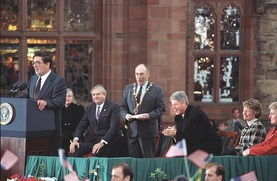 John Hume - SDLP Leader John Hume introduces President Bill Clinton who is seen laughing with the crowd.