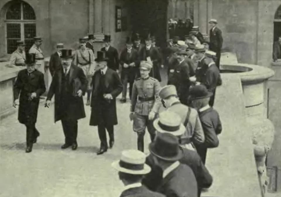Karl Renner - Dr. Karl Renner, head of the Austrian delegation at the Peace Conference, leaving with other delegates with the treaty in a portfolio, Chateau of St. Germain.