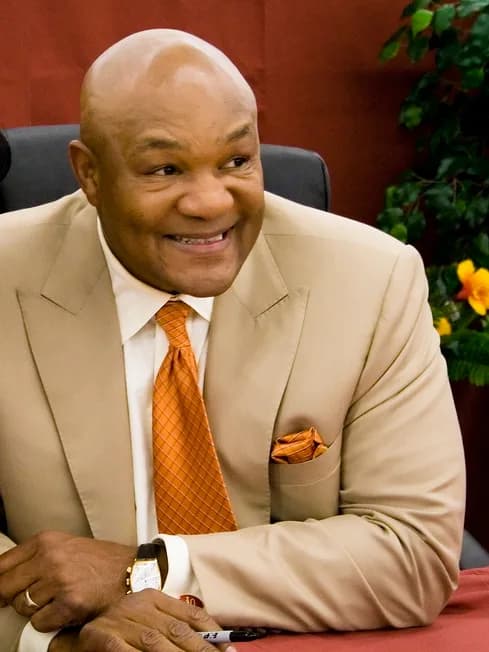 George Foreman - George Foreman, of grilling fame, poses for a picture with a female fan and fellow Wal-Mart shopperGeorge Foreman and Woman