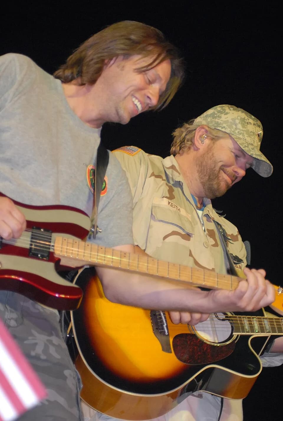 Toby Keith - Camp Victory, IQ - Toby Keith and guitarist Richard Eckhardt enjoy themselves while inspiring fans with their patriotic music.
