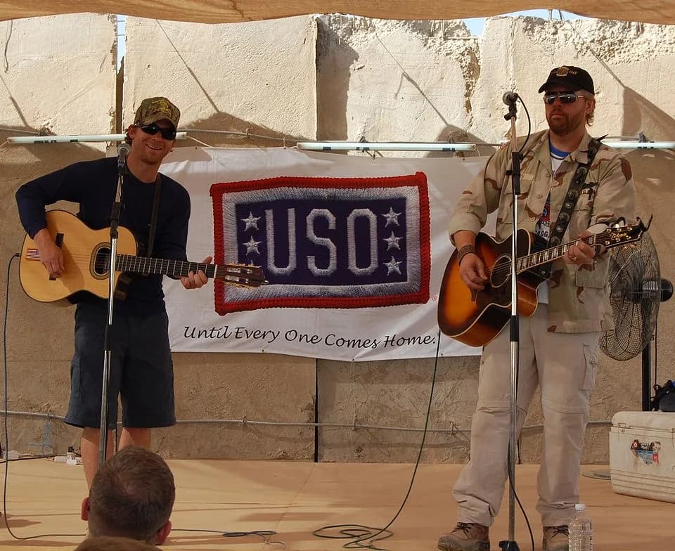 Toby Keith - Toby Keith (right) and Scott Emmerick play an acoustic set for the Soldiers of 1-15th Infantry Regiment at Combat Outpost Carver, Salman Pak, Iraq, April 26. Keith included the outpost in